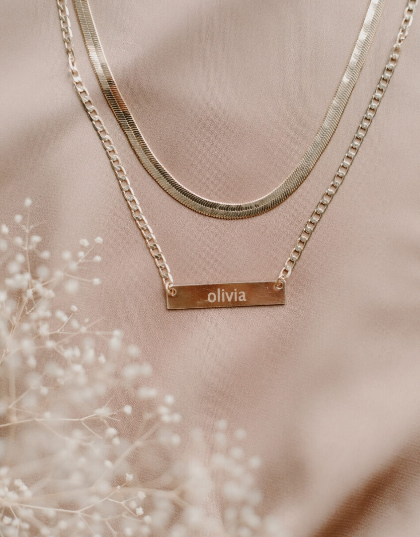 Flatlay image of Layered Gold-Filled Herringbone Name Bar Necklace