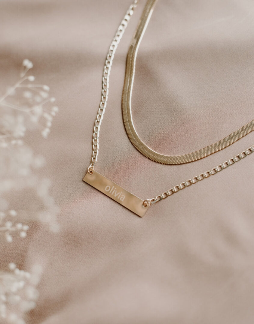Flatlay image of Layered Gold-Filled Herringbone Name Bar Necklace
