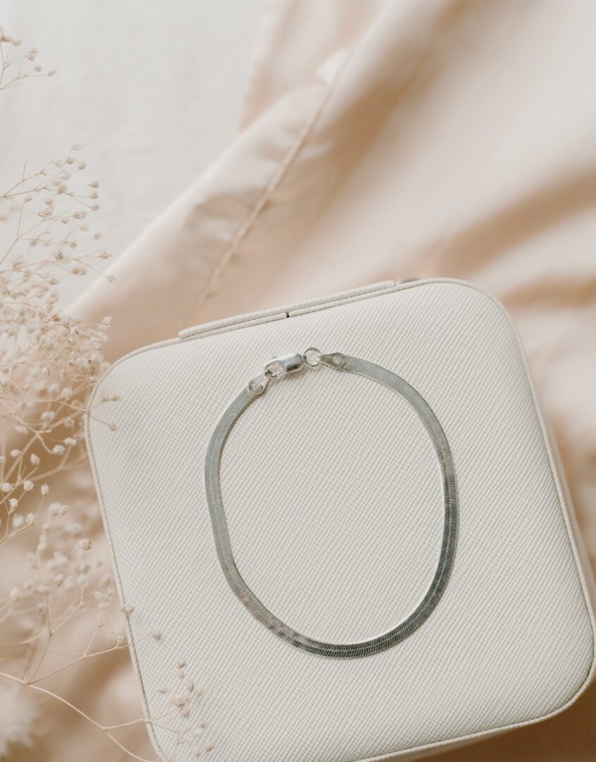 Flatlay image of Sterling Silver Herringbone Bracelet on jewelry case