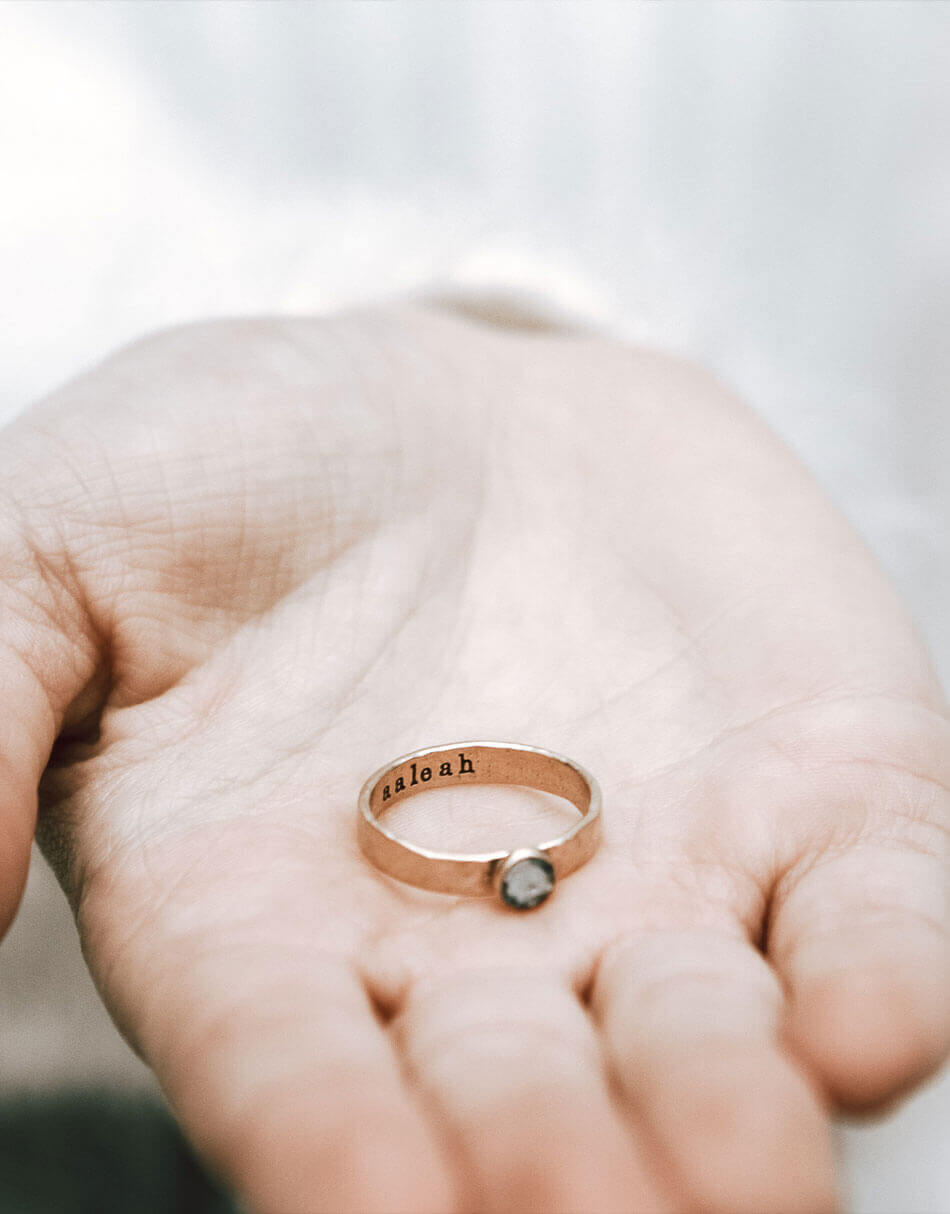 Sterling Silver handmade band with a birthstone and a name hand-stamped. Can be stacked with other rings