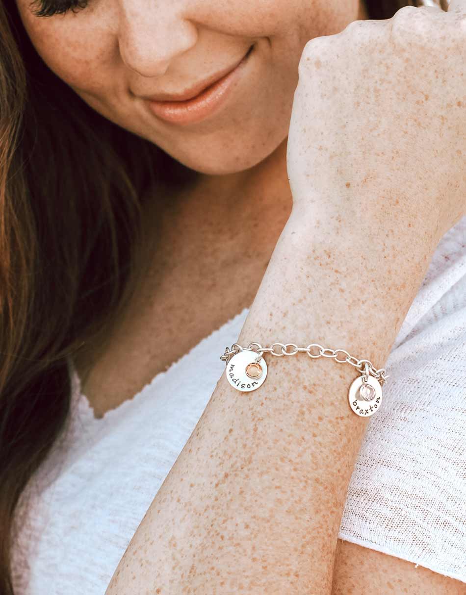 A beautiful Swarovski birthstone crystal drop hangs with each name charm. Perfect for Moms, grandmas.