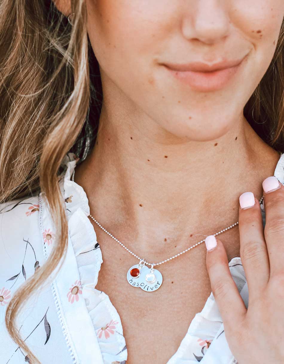 Personalized necklace with small sterling silver circle charms, hand-stamped around the edge with names or words.