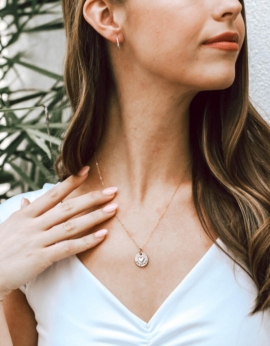 A dainty disc with a heart soldered on it and a name hand-stamped. Personalized necklace for wife.