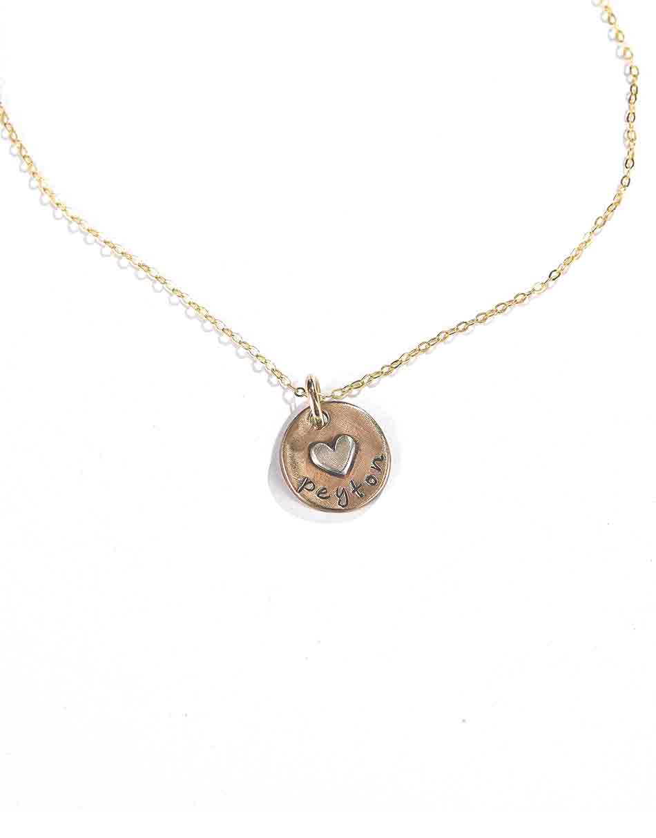A beautiful gold-filled disc with a gold-filled or sterling silver heart soldered on it. Hand-stamped with name. Best gift for mom, or wife