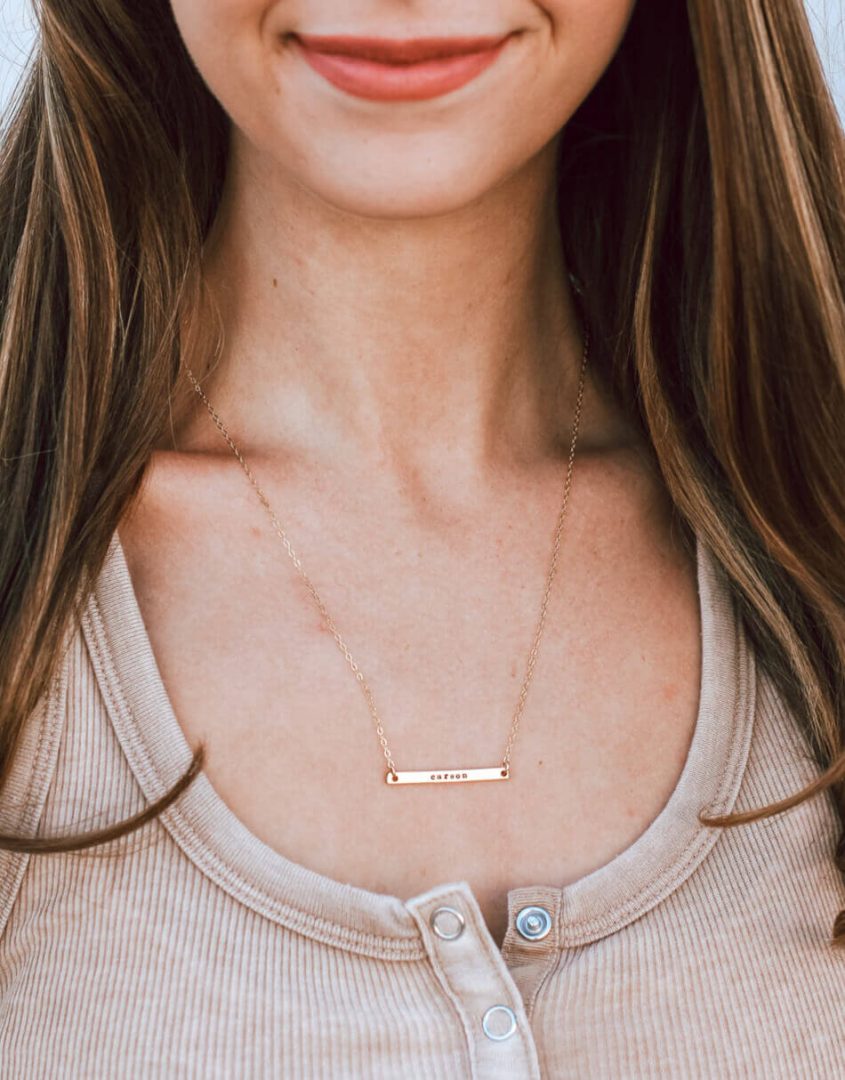 A sterling silver or gold-filled dainty bar with name hand-stamped. Personalized necklace for women of any age