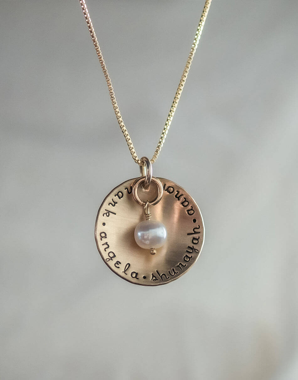 A gold disc with names hand stamped. Perfect as mothers day gift for mom, grandma