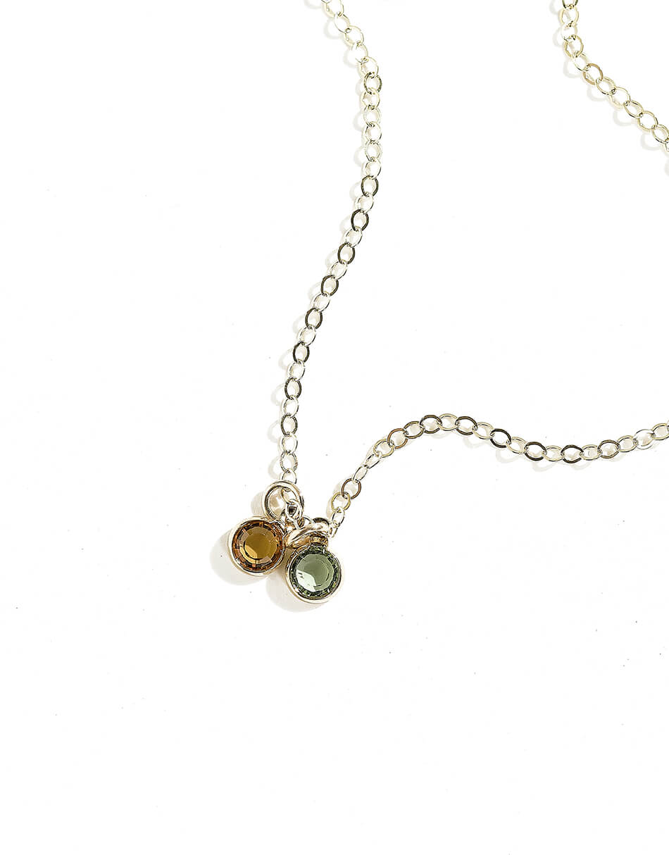 Each charm is adorned with a Swarovski birthstone. Choose the length of the gold-plated chain and the number of drop charms for all your loved one