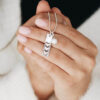 A handmade sterling silver charm with stacked golden hearts, one for each of Mom’s loves. Personalized necklace for moms