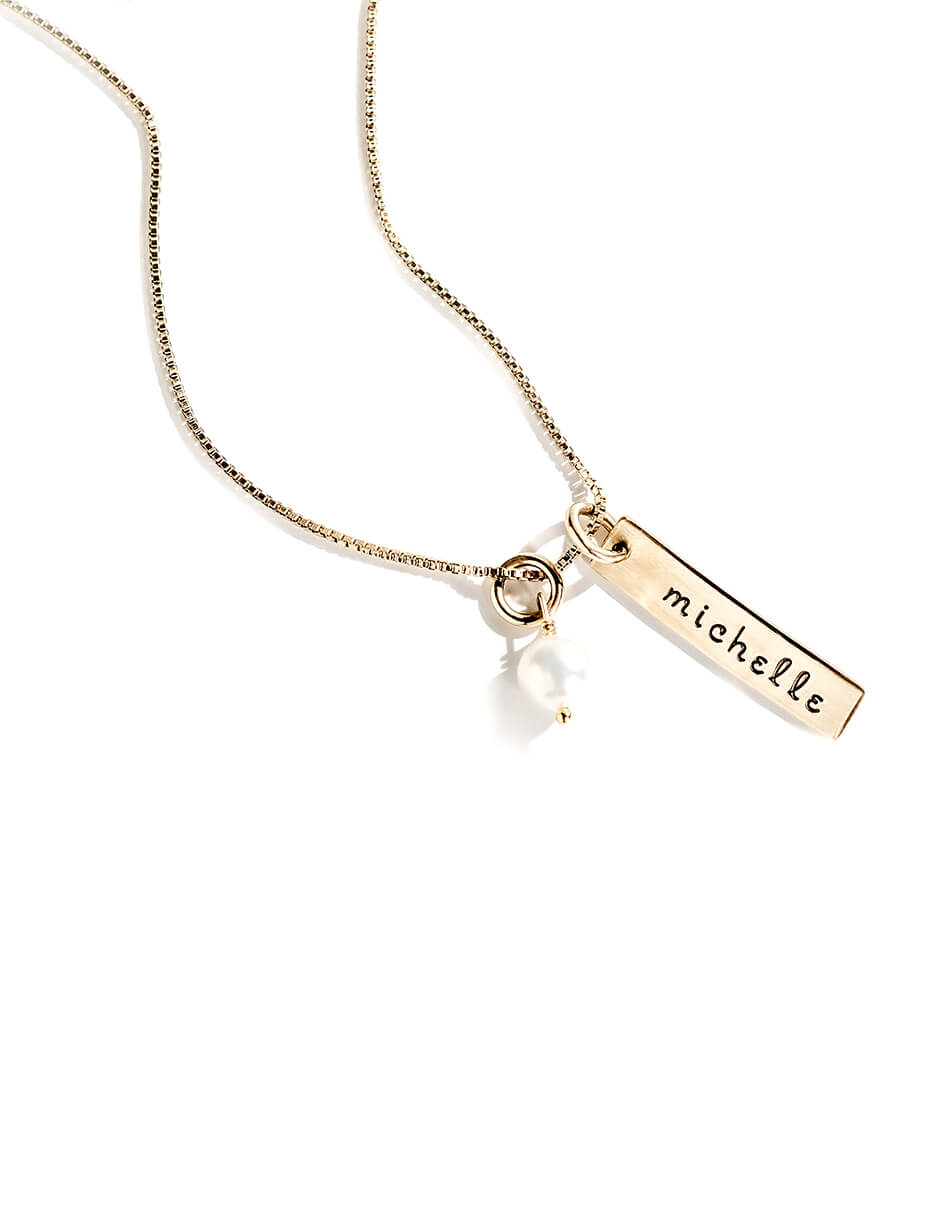 Golden rectangle bar with name engraved on it, along with a freshwater pearl. Perfect for mom, grandma, sister, friend.