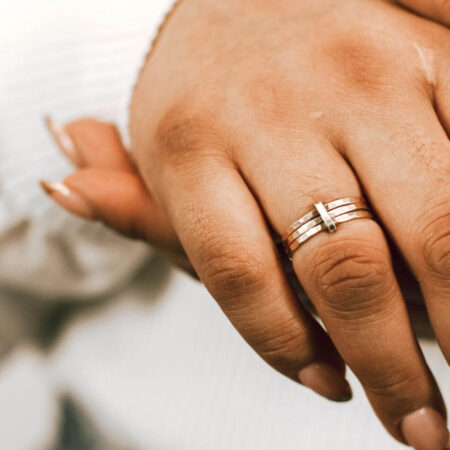 A golden metal “tie” binds together sterling silver rings- each ring represents a member of your family. Personalized Ring for wife or mom