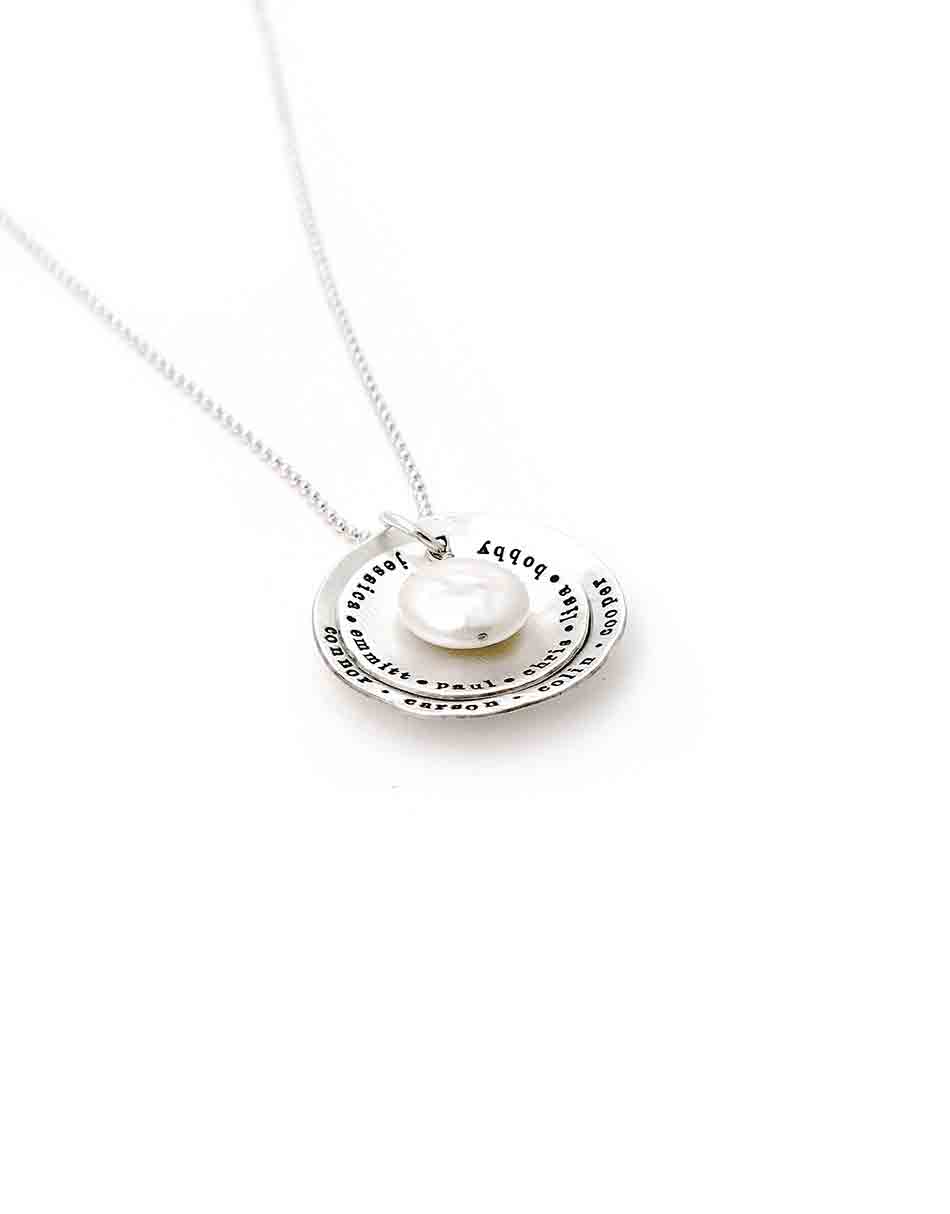 Hand stamped with names, these 2 sterling silver discs have a mother of pearl hanging in the middle. Personalize jewelry for grandma, mom