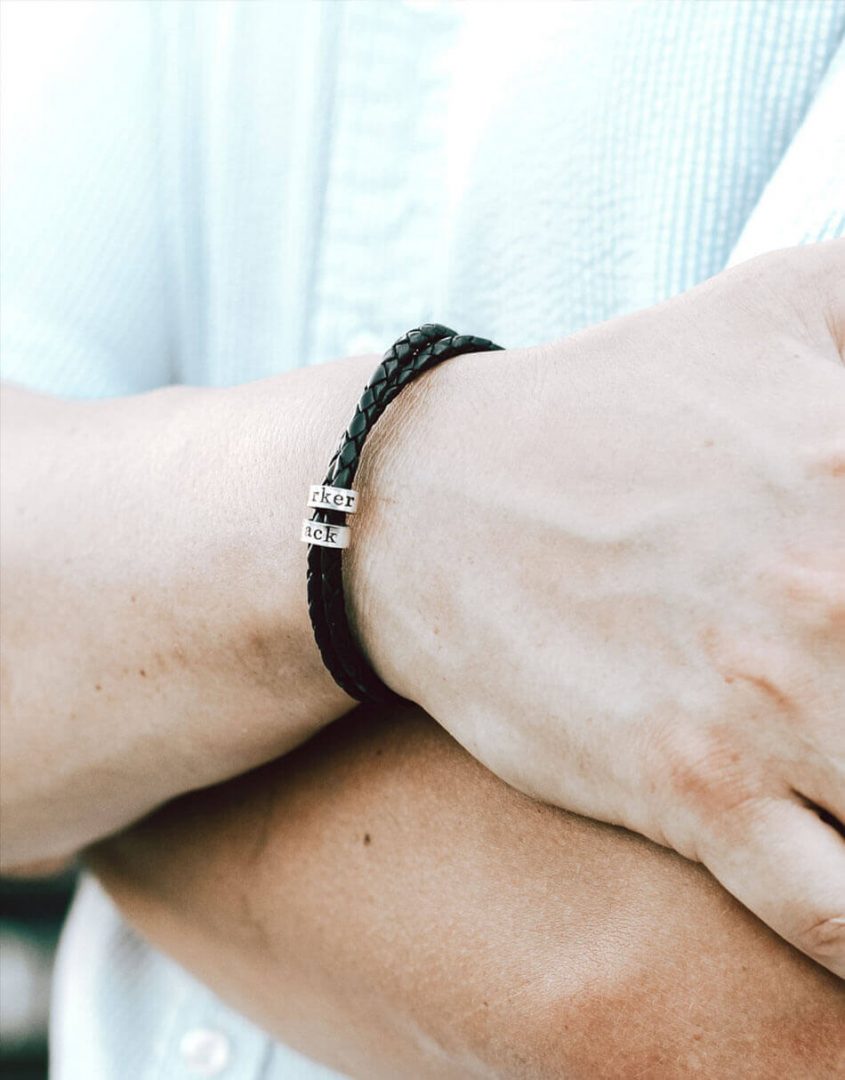 Black leather braided bracelet wrapped with sterling silver custom made rings hand-stamped with text