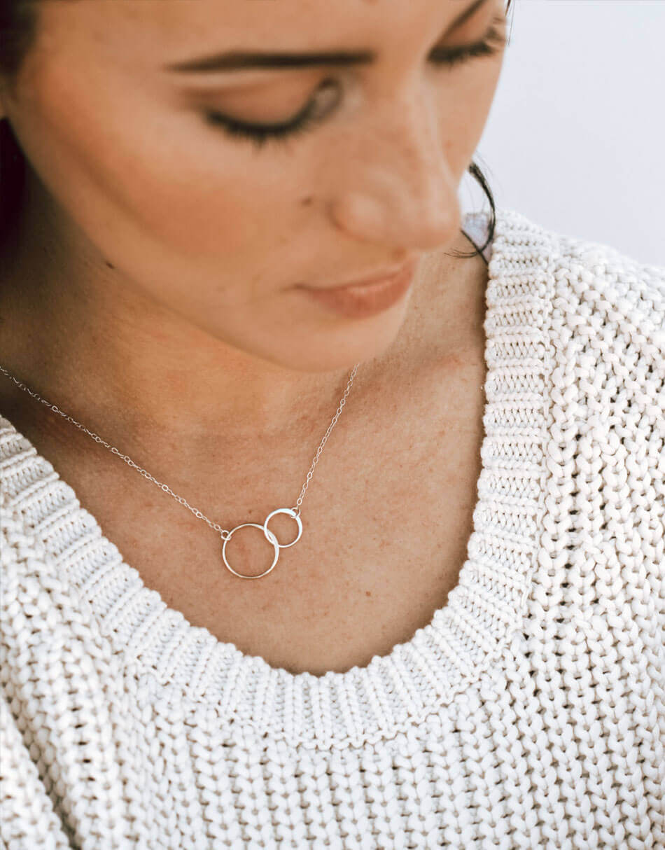 2 sterling silver circles connect together and are hung on a sterling silver dainty chain