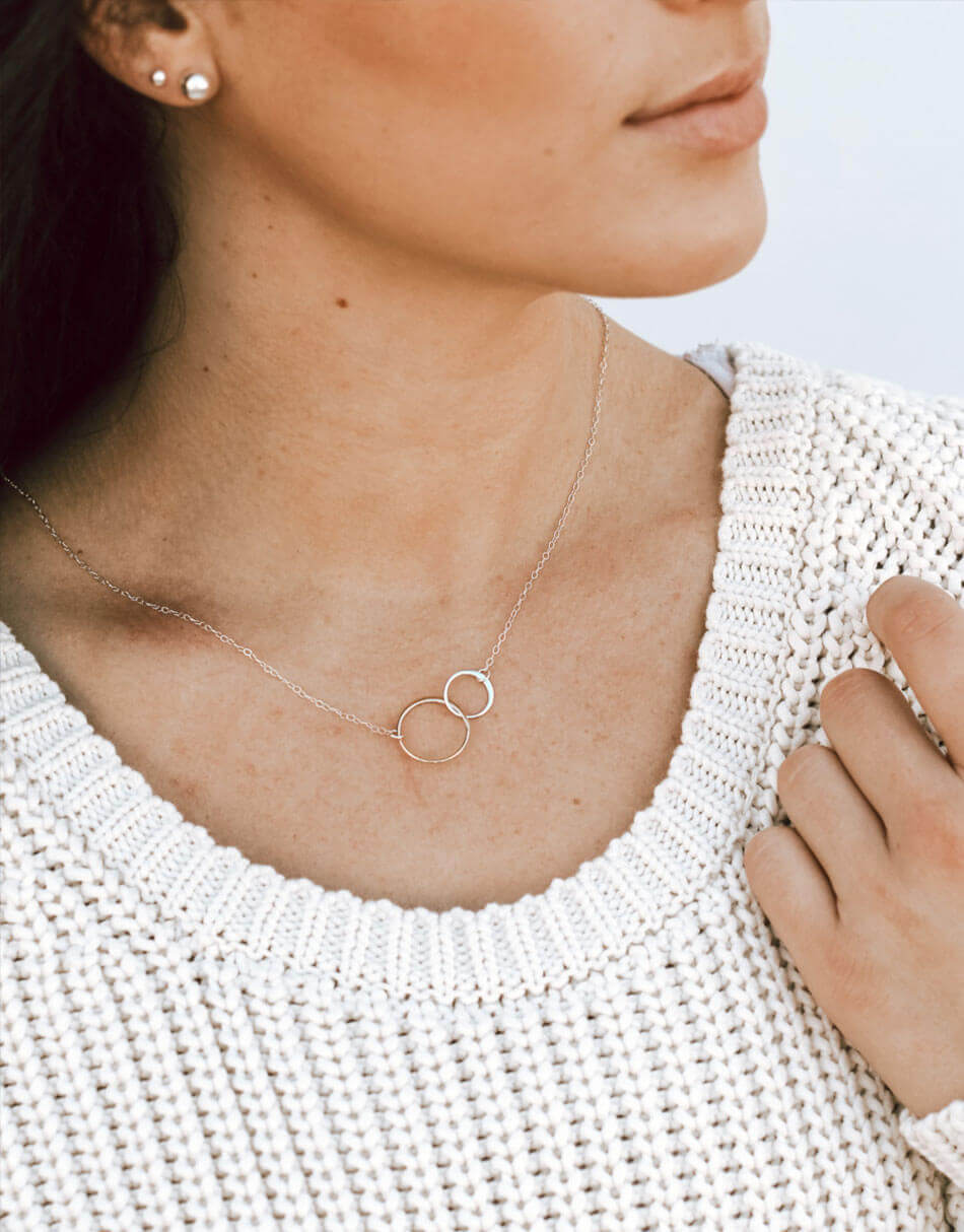 2 sterling silver circles connect together and are hung on a sterling silver dainty chain