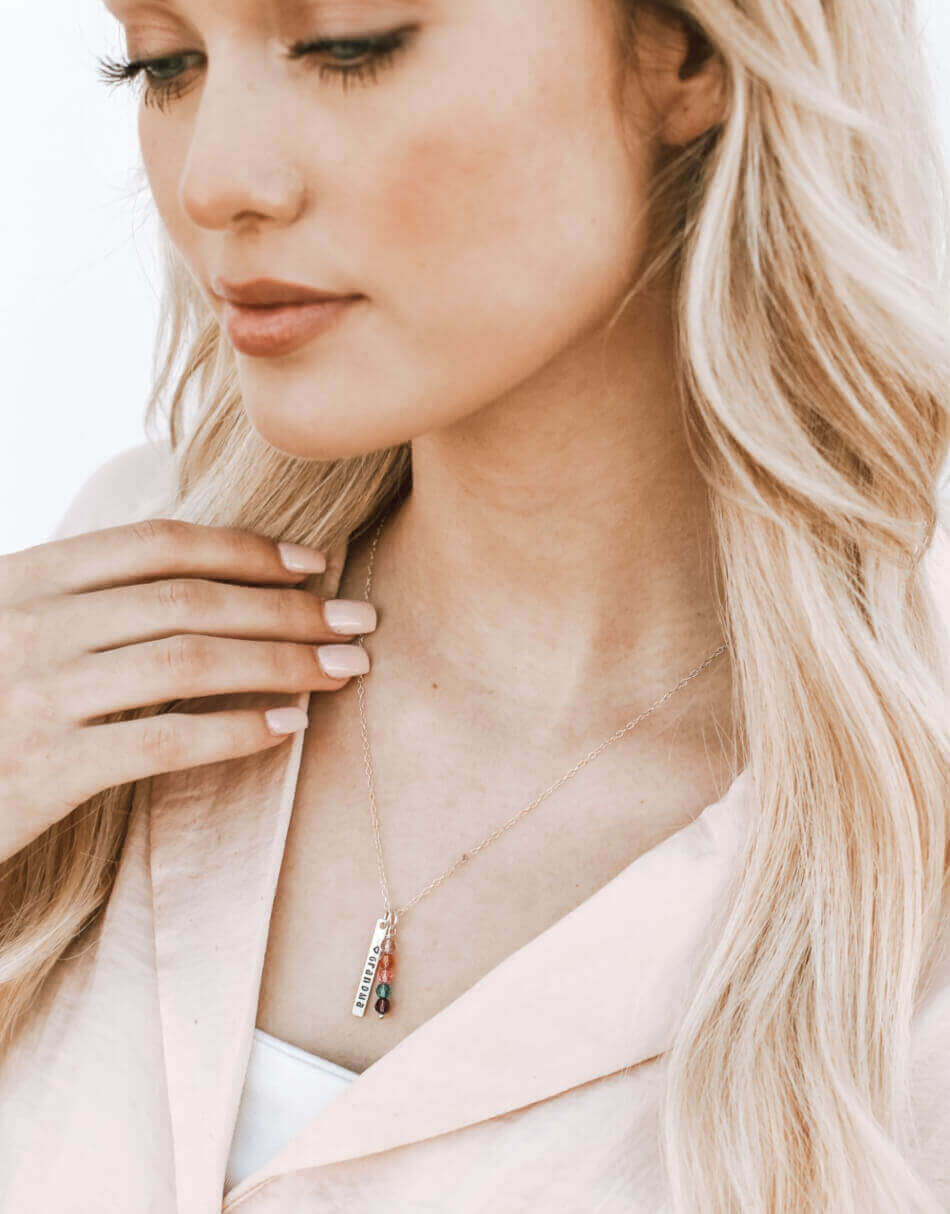 A beautiful family keepsake in sterling silver or gold-filled. Engrave the name on the rectangle charm with family birthstones.