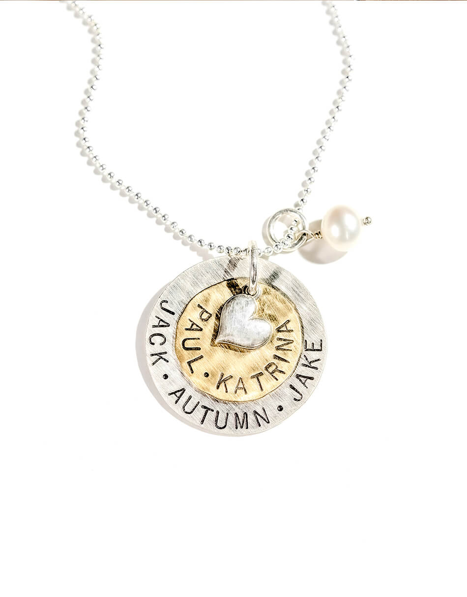 Customized sterling silver disc and the brass disc with names along with a silver heart and a fresh water pearl. Personalized necklace for wife