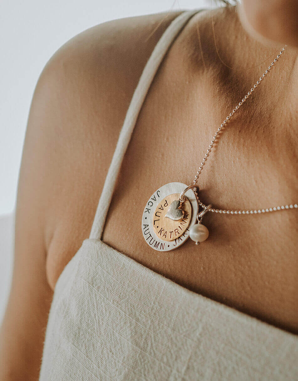 A large sterling silver disc layered with a brass disc and topped with a silver heart. Personalized necklace for grandma, mom