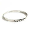 Sterling silver bangle hand stamped on inside with names or a message and hearts on the outside. Personalized bracelet for wife