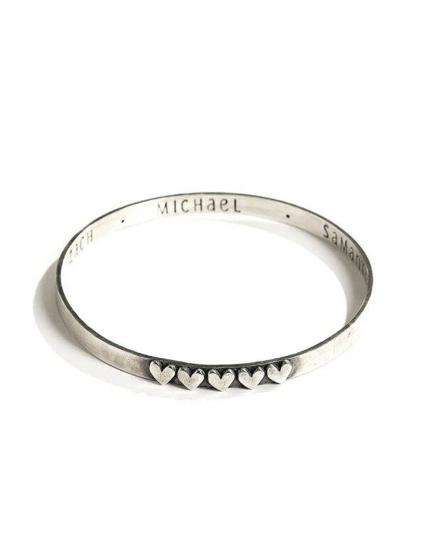 Sterling silver bangle hand stamped on the inside with names or a secret message. Add hearts on the outside for each name.
