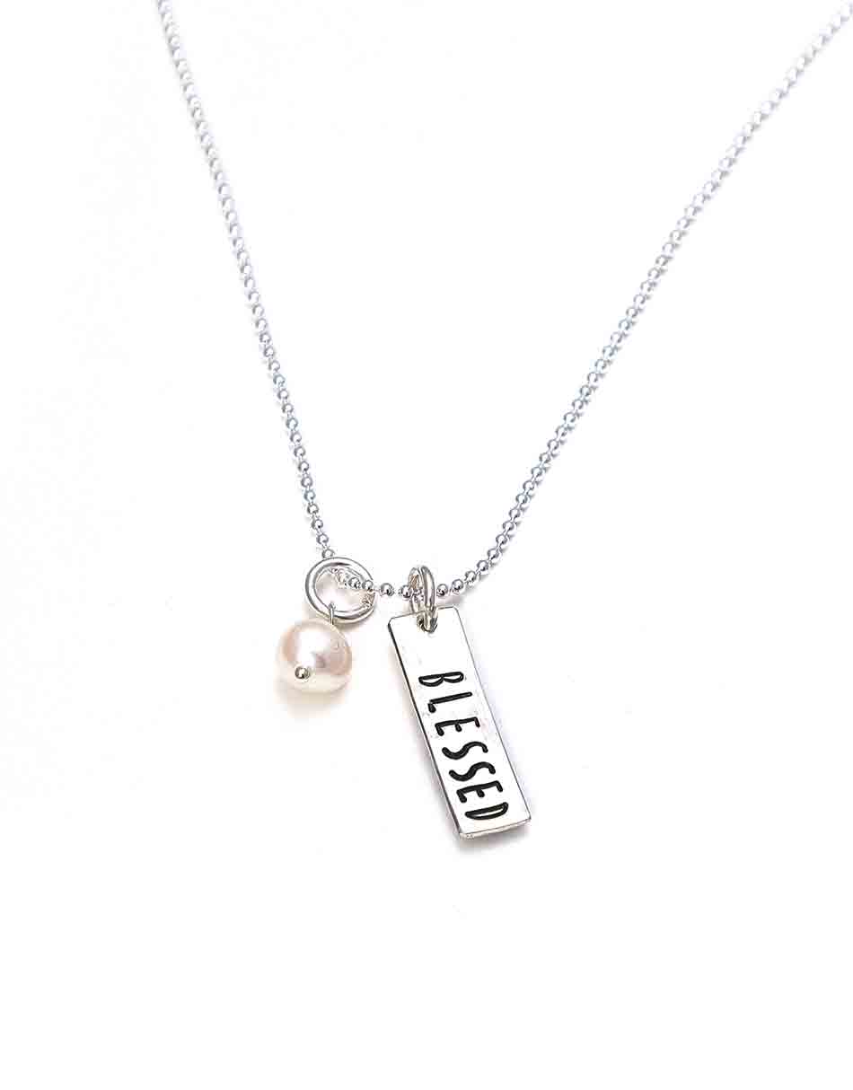 Sterling silver rectangle bar charm with stacked hearts on one side and name hand stamped on the back. Personalized jewelry for mom