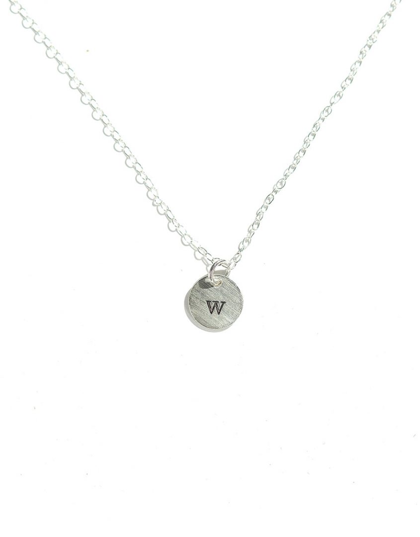 Hand-stamped initial on a tiny sterling silver disc. Best personalized necklace for mom, new mom or wife