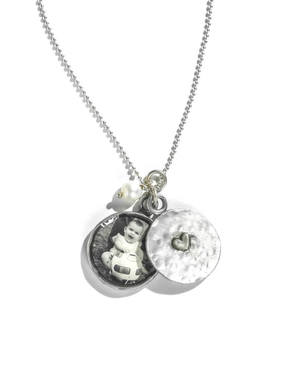 A 2 piece locket, hand stamped on the inside with names or date and the bottom piece has the pick of your little one. Best gift for mom